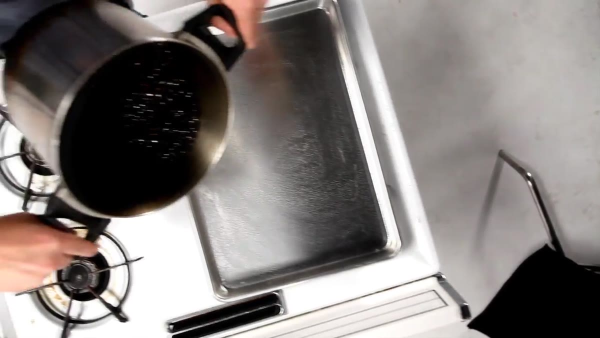 Mixture being poured onto sprayed cookie sheet
