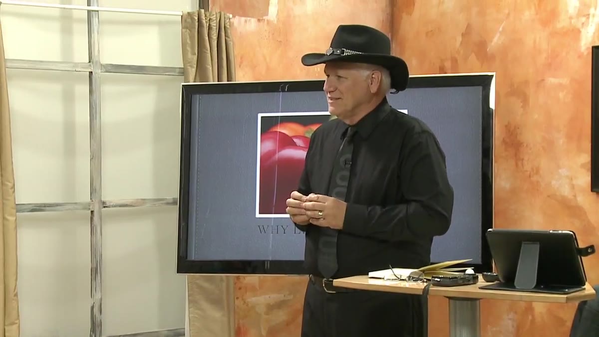 Don Giannatti gesturing, explaining that everything reflects light