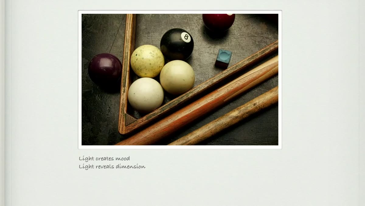 Pool balls on a table showing varied reflections from single light source