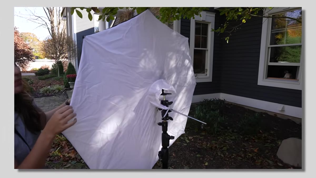 Tony holding a flash unit, making the case for artificial light