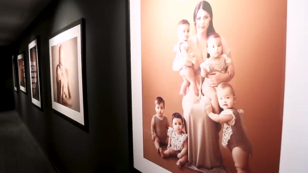Framed archival prints hung gallery-style along the studio walls