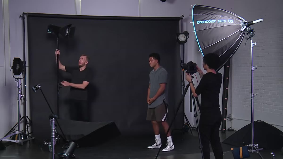 Photographer describing light placement to wrap the subject