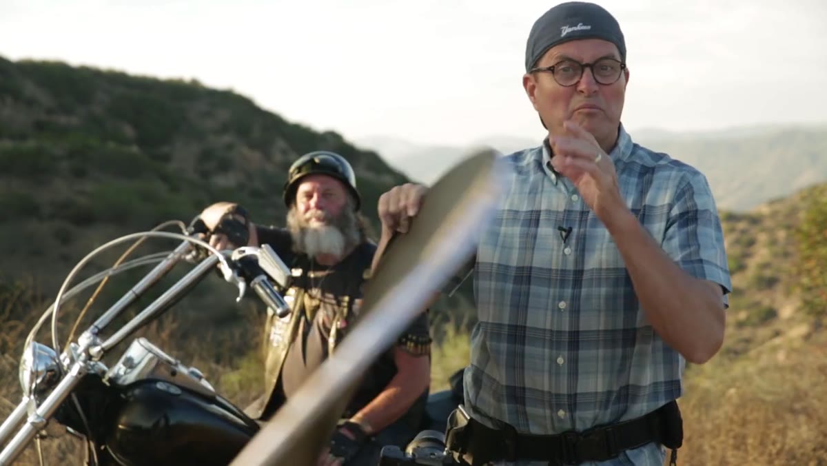 Jay holding a 7-in-1 reflector showing black and white sides