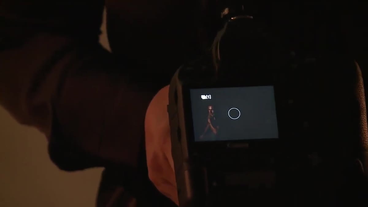Photographer repositioning camera to align second shot with base plate