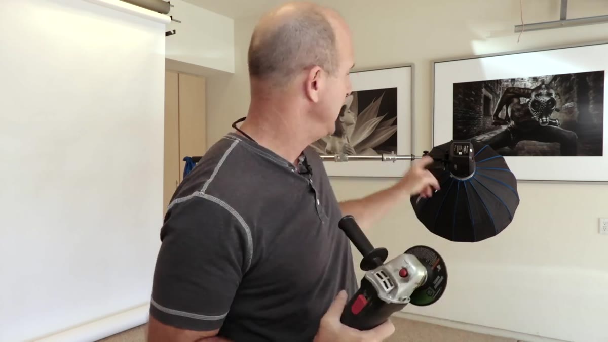 Handheld angle grinder shown against boom pole end