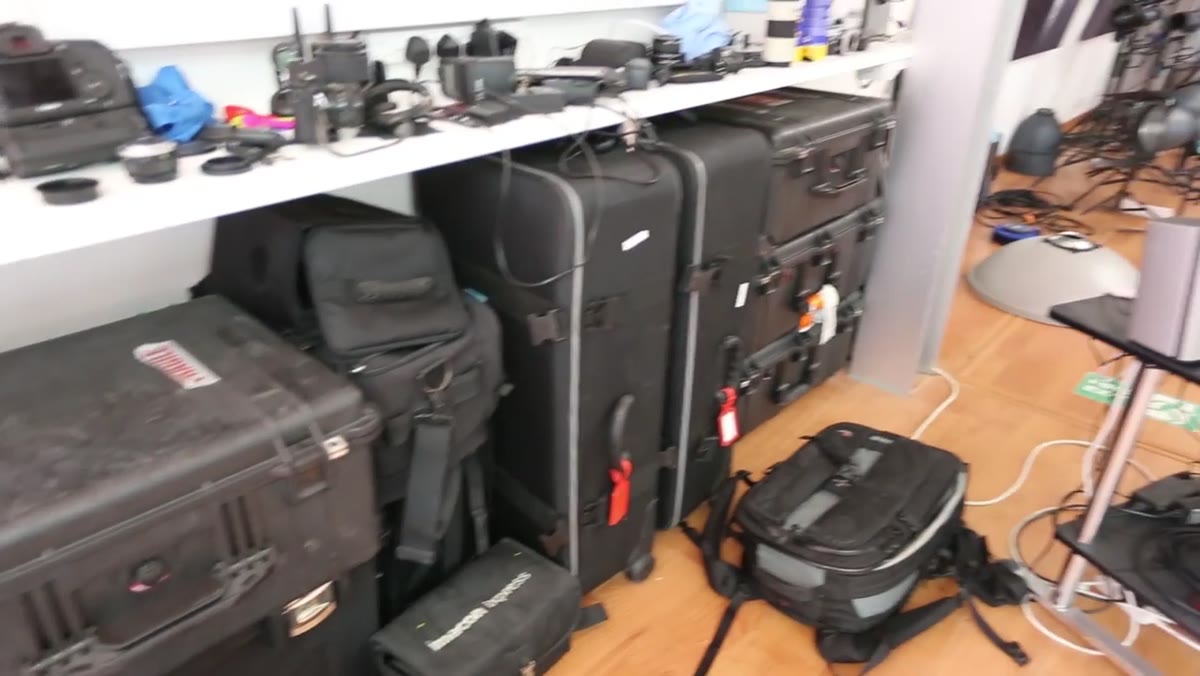 Flight cases lined up along the studio wall near the exit