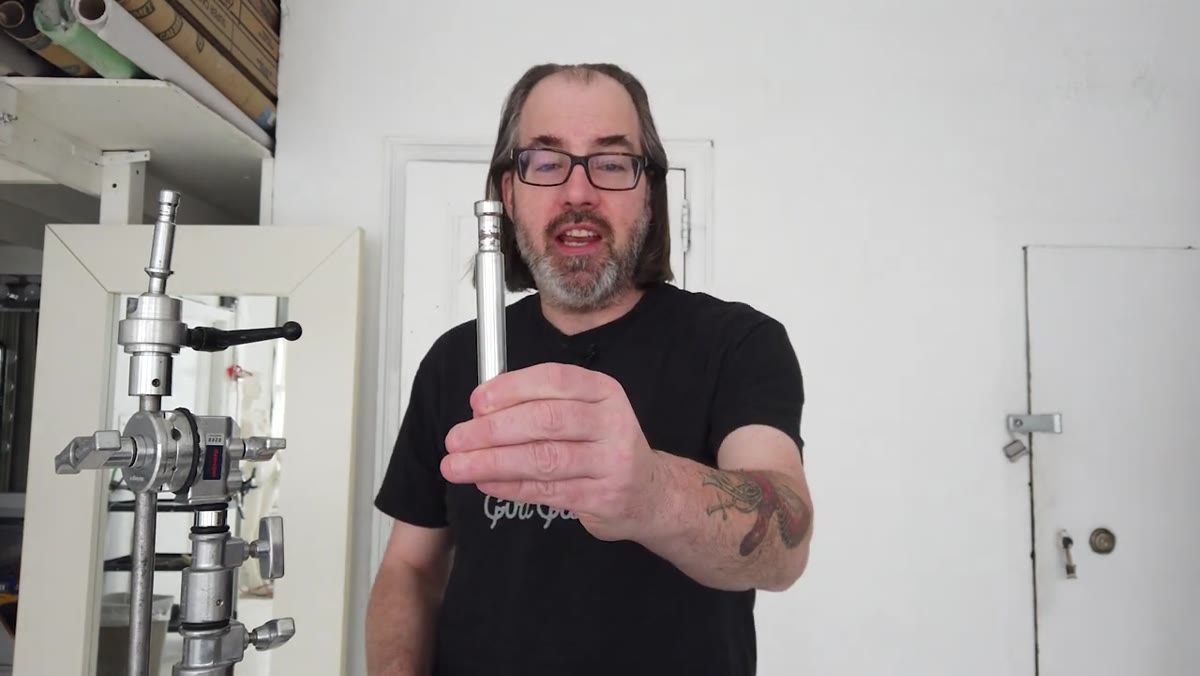 Baby pin on C-stand arm held up to camera