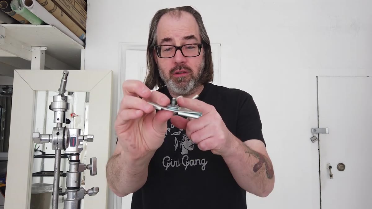 Quarter-20 threaded fitting being unscrewed from adapter