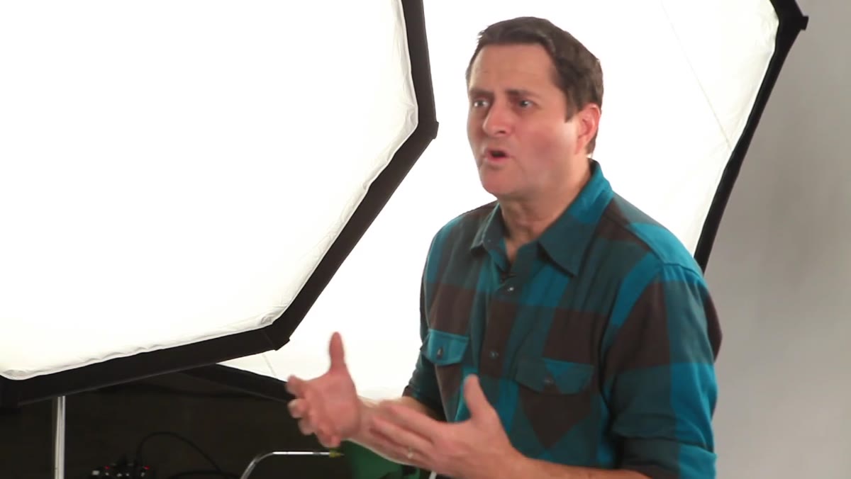 Host explaining octodome against a plain studio background