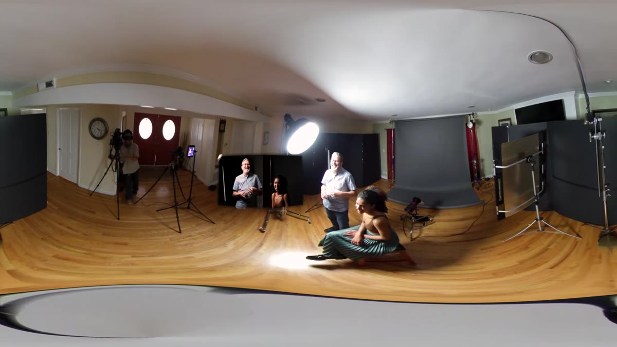 Photographer positioning key light in Rembrandt location