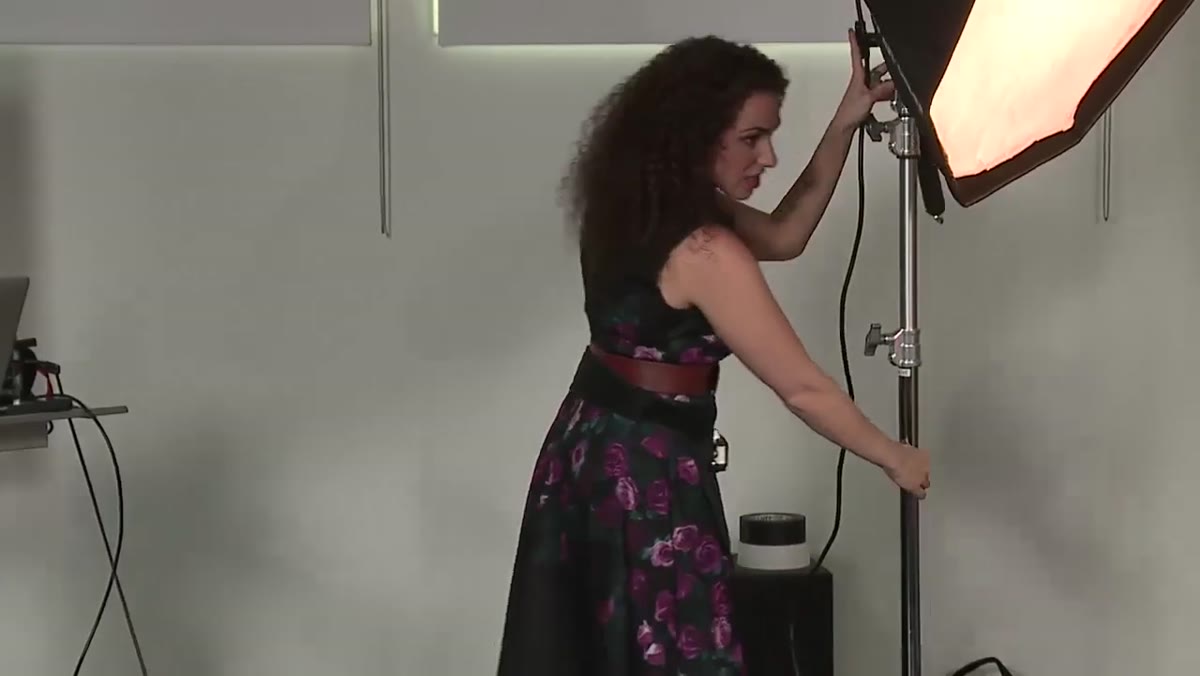 Silver reflector positioned beside main strobe in studio