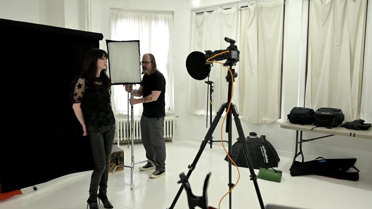 Light being moved to the far side behind the subject