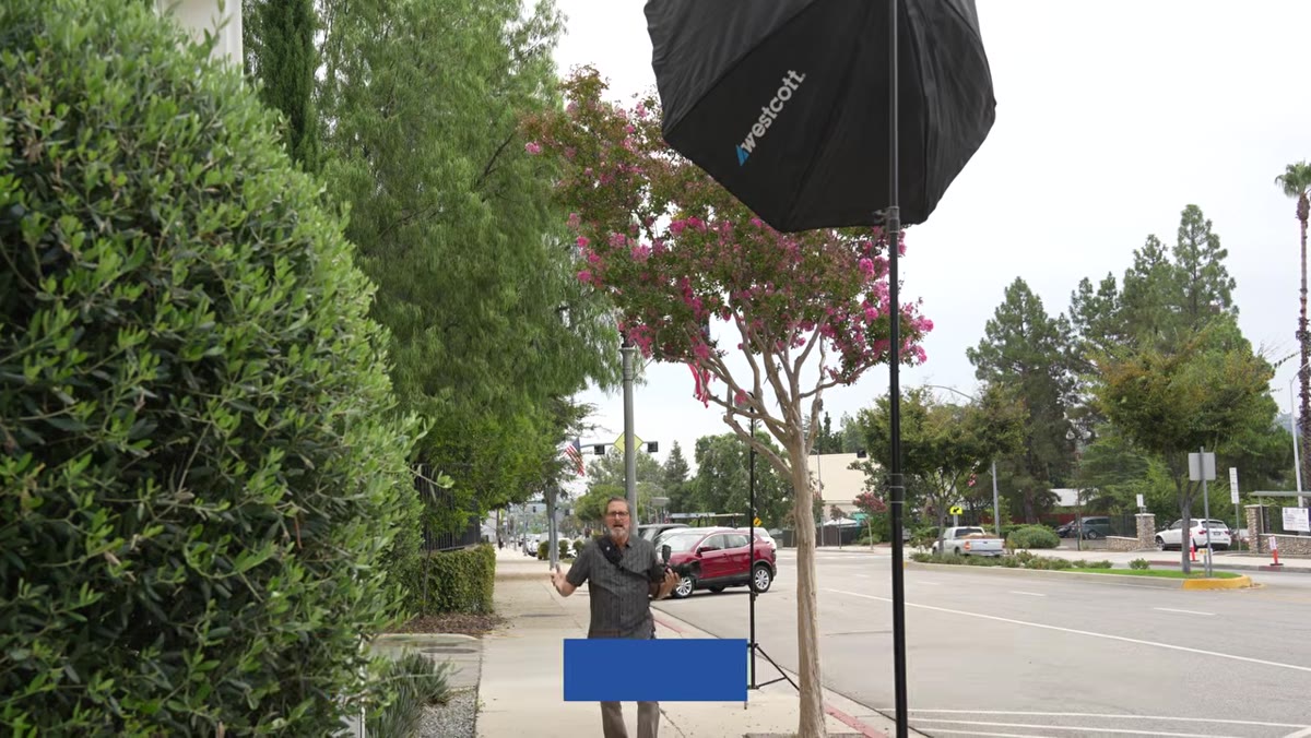 Large softbox positioned high above camera axis, aimed down at subject area