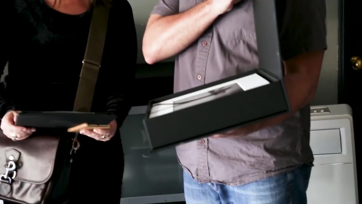 Paul demonstrating the weight of a filled folio box