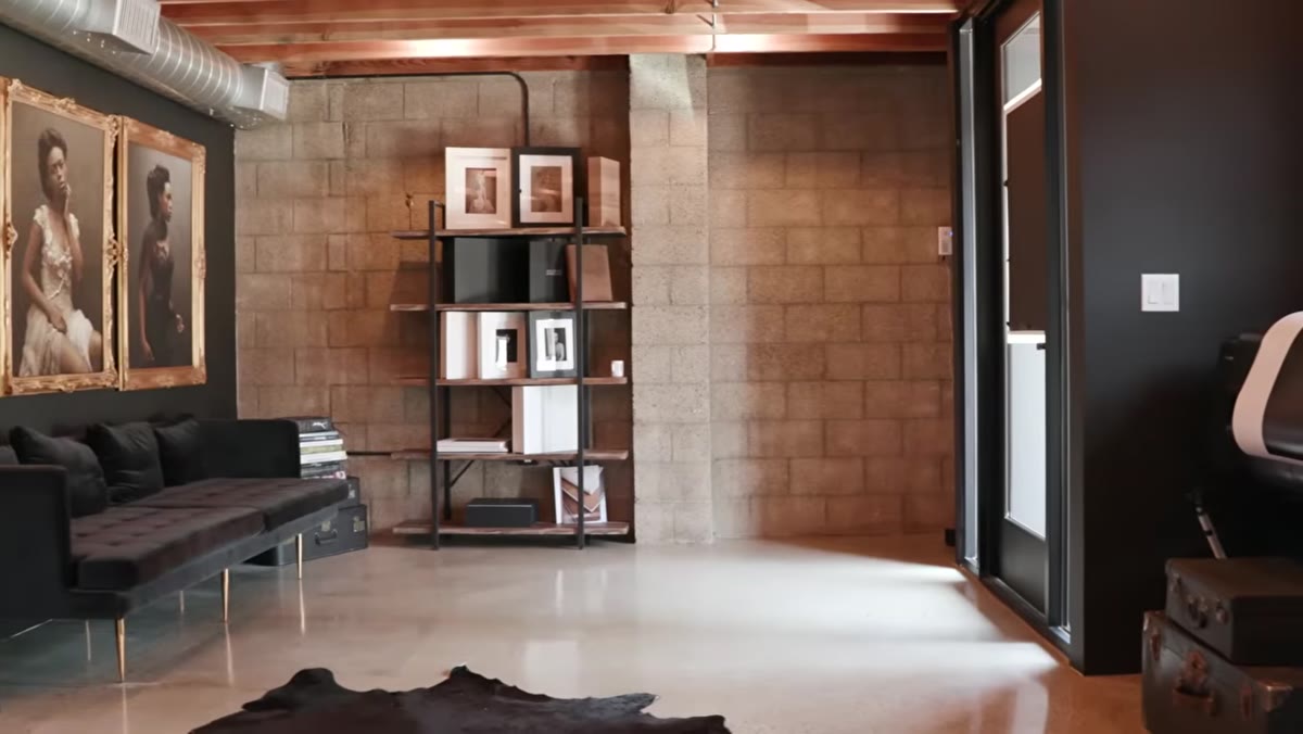caption: Frames, albums, and printed boxes arranged in the studio entrance